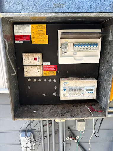 Switchboard needing upgrade with various electrical components showcased, featured by Activ Electrical Contracting.