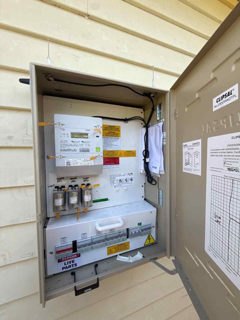 Electrical switchboard installation showcasing circuit breakers and safety labels for residential use.