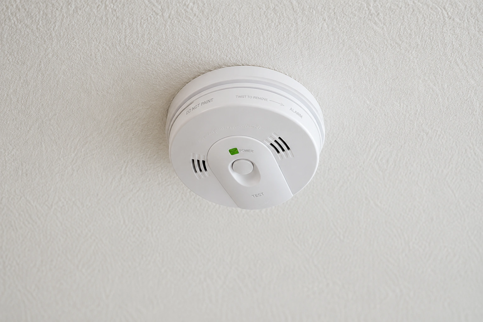 Smoke alarm installed on ceiling, highlighting safety compliance for Kempsey homeowners by <a href=