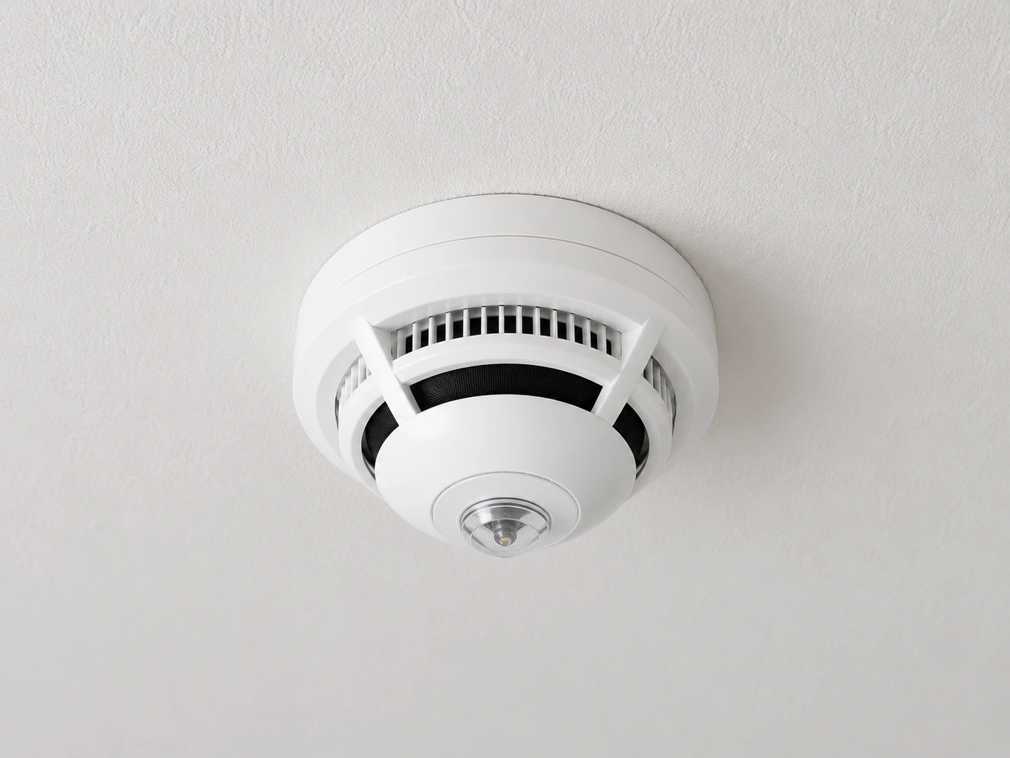 Smoke alarm installed on ceiling, essential for safety compliance in NSW homes, by Activ Electrical Contracting.